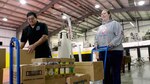 Small Tribes of Western Washington’s David Gibson helps Titiana Burks
collect her food order at the STOWW distribution center in Lakewood.
