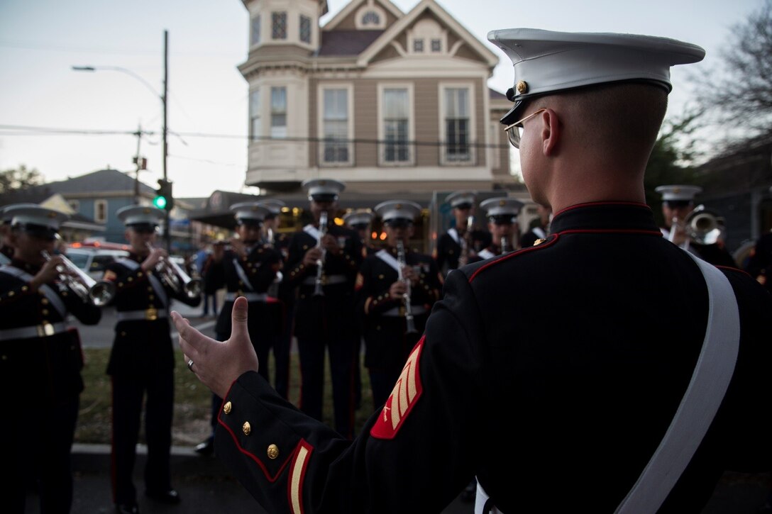 Sgt. Dalton M. Guin, assistant enlisted conductor for Marine Corps Band New Orleans, Marine Forces Reserve, leads the band in a rehearsal before marching in the Krewe of Druids parade during Mardi Gras in New Orleans, Feb. 22, 2017. The band participated in numerous parades to promote the Marine Corps and support the New Orleans community. (U.S. Marine Corps photo by Cpl. Melissa Martens/ Released)  