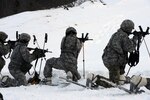 Soldiers use their ski poles as bipods in order to get good firing positions during the biathlon, Feb. 18, 2017. 