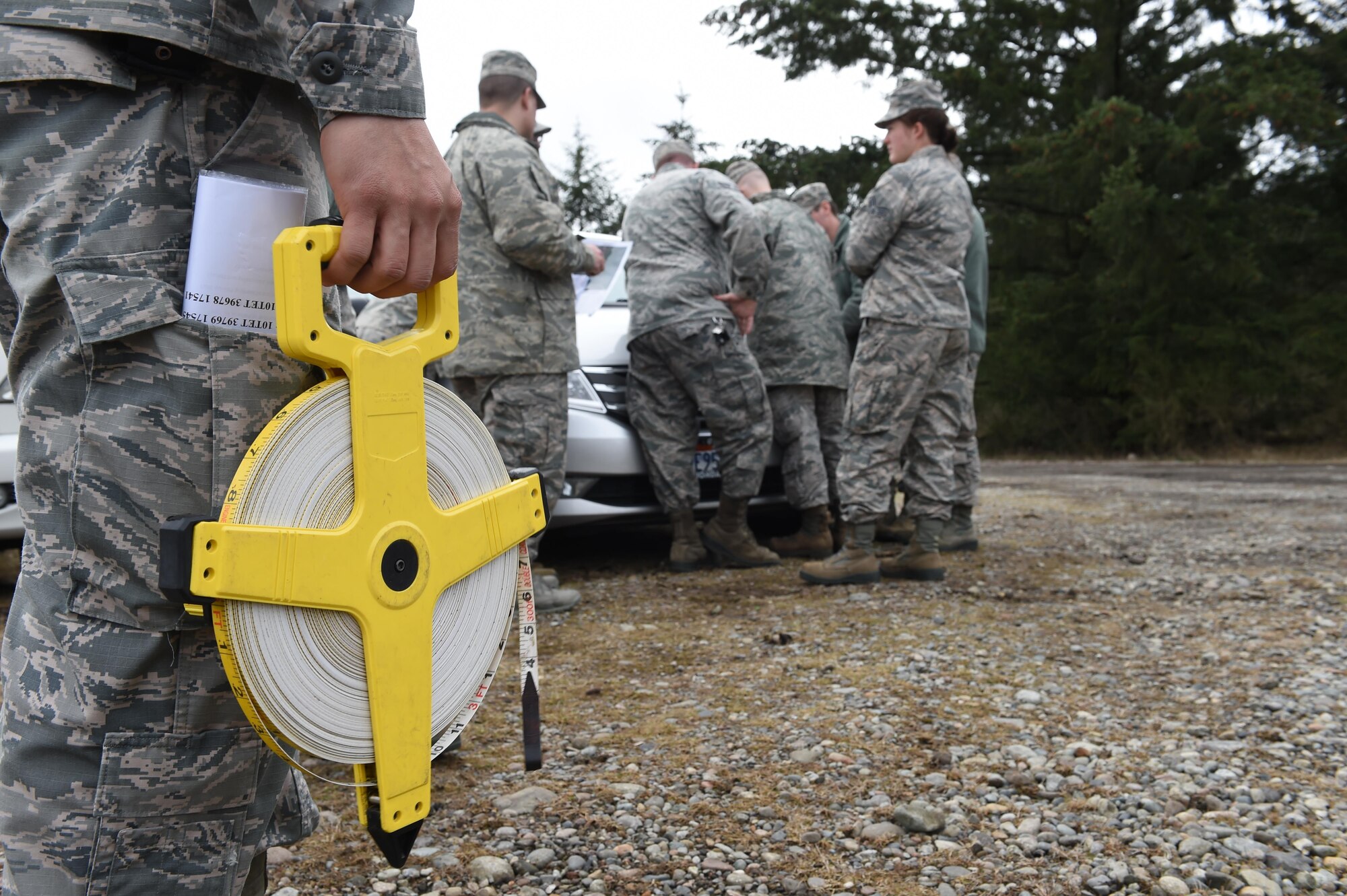 Staff Sgt. Jesse Reyes, 627th Security Forces Squadron combat arms instructor, holds measuring tape prior to the 627th Civil Engineer Squadron’s land navigation training on Joint Base Lewis-McChord, Wash., Feb. 16, 2017. More than 50 627th CES Airmen participated in the training here where they learned map orientation, grade ordinates and how to use an azimuth. (U.S. Air Force photo/Staff Sgt. Naomi Shipley)