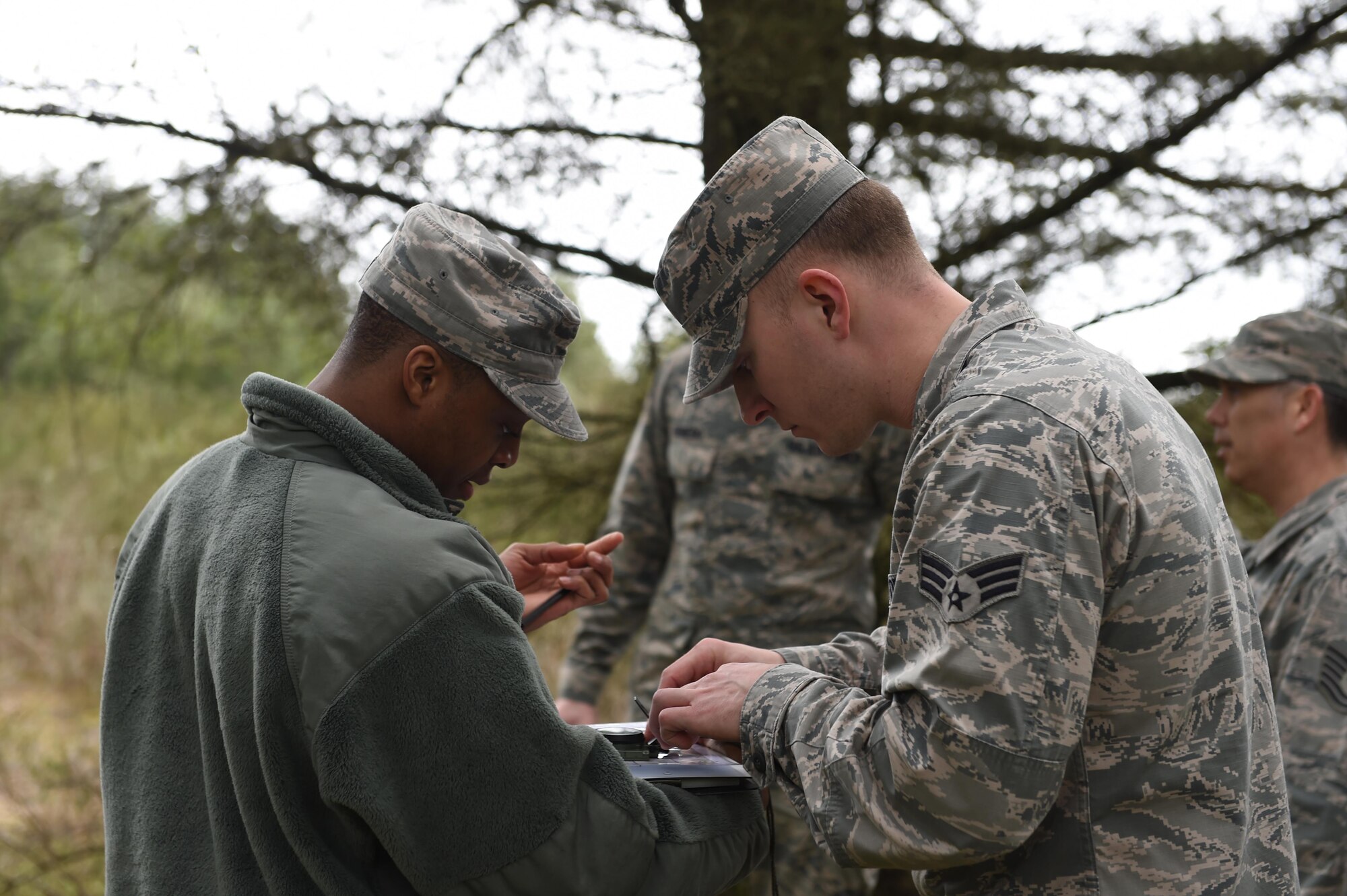 Members of the 627th Civil Engineer Squadron conduct land navigation training on Joint Base Lewis-McChord, Wash., Feb. 16, 2017. 50 Airmen were split up into nine teams and used a compass and azimuth to navigate to three different coordinates and back to the start. (U.S. Air Force photo/Staff Sgt. Naomi Shipley)