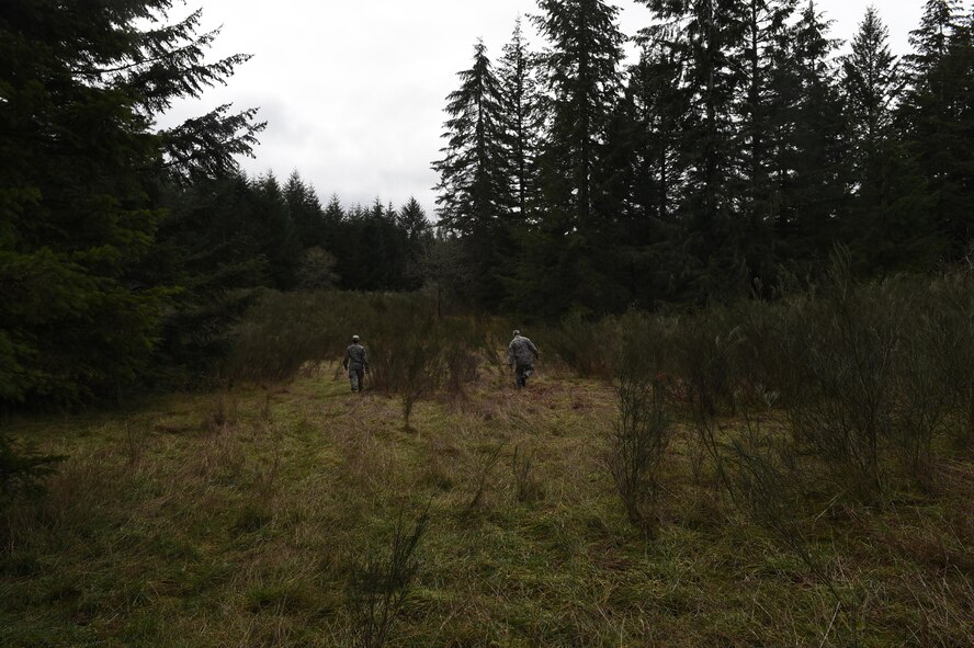 Members of the 627th Civil Engineer Squadron walk through thick brush on Joint Base Lewis-McChord, Wash., Feb. 16, 2017. The team traveled more than 1,500 meters in approximately two hours to reach their three coordinates using a compass, map and azimuth. (U.S. Air Force photo/Staff Sgt. Naomi Shipley)