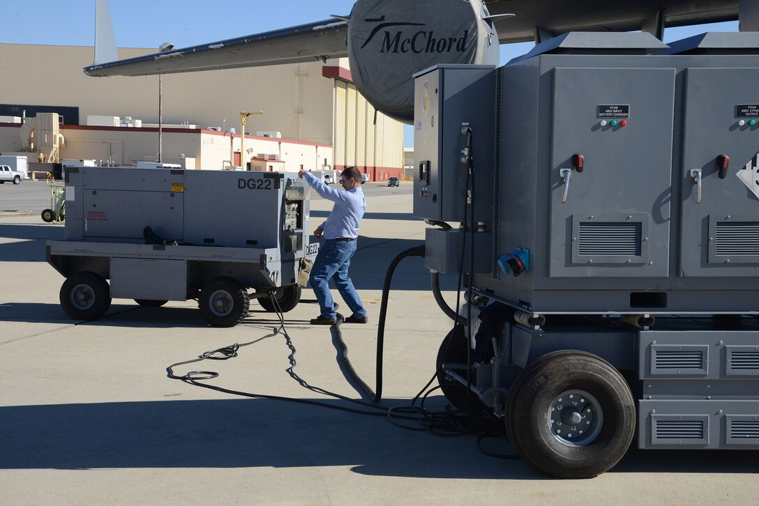 Ryan Tipton, 412th Maintenance Squadron, fires up a legacy diesel generator to recharge the Hybrid Electric Flightline Cart Technology Pathfinder on the flightline here. The HEF maintained enough power to complete the required C-17 checks before it was due a recharge. (U.S. Air Force photo by Christopher Ball)