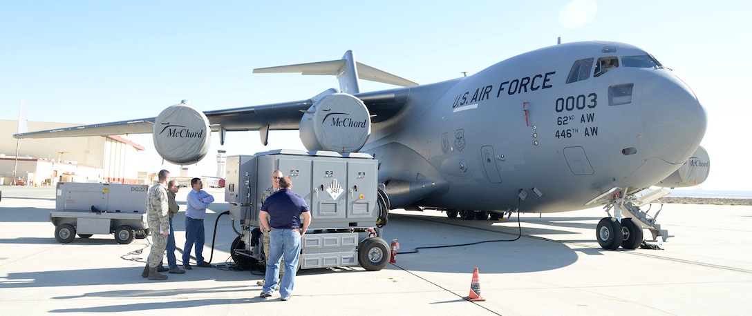 The test team monitors the HEF during the C-17 portion of the Hybrid Electric Flightline Cart Technology Pathfinder tests. The HEF was a concept demonstrator built to explore an all-electric or hybrid electrical power supply for use by flightline maintainers. Some possible advantages are lower noise, less emissions and less maintenance than the diesel generators currently in use. (U.S. Air Force photo by Christopher Ball)