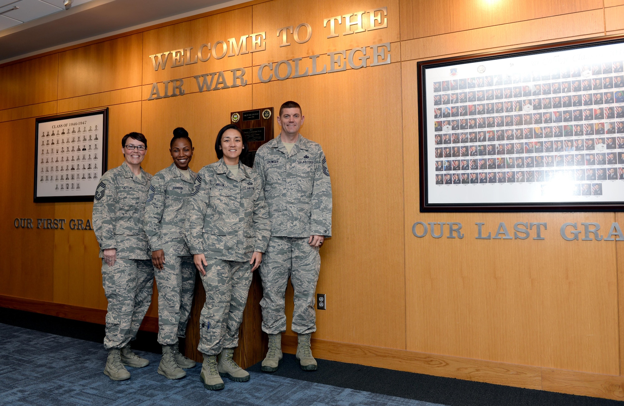 Chief Master Sgts. Amber Mitchell, Shanece Johnson, Kimberly Vinson and Derek Crowder stand in the Air War College lobby at Maxwell Air Force Base, Feb. 23, 2017. They are the first enlisted Airmen to attend the college as in-resident students. (U.S. Air Force photo by Senior Airman Tammie Ramsouer)