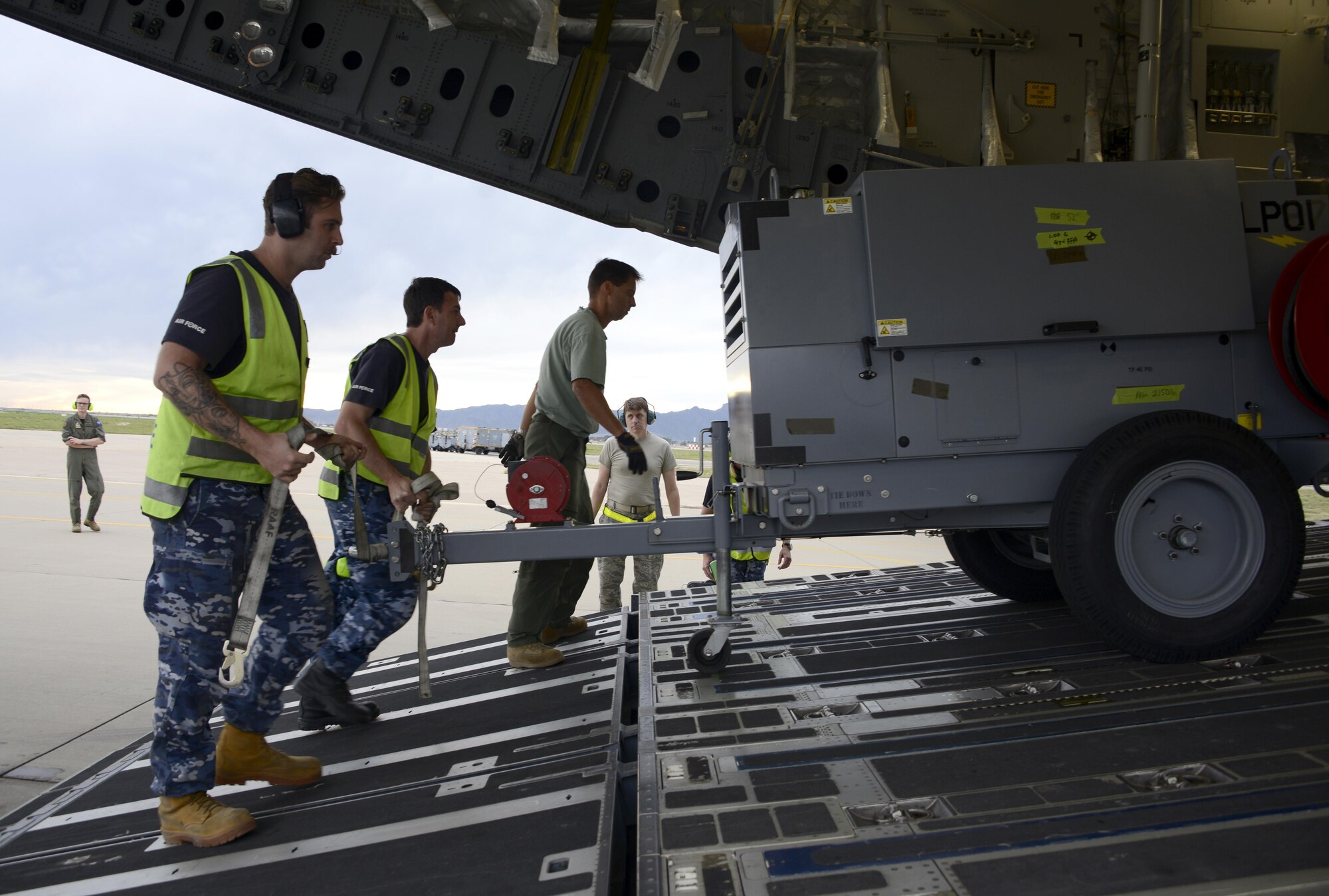 Royal Australian air force airmen prepare to load a pallet onto a RAAF C-17 Globemaster III cargo aircraft Feb. 22, 2017, at Luke Air Force Base, Ariz. Through logistical planning and preparation, supply equipment is carefully loaded onto aircraft in order to balance the pay load. (U.S. Air Force photo by Airman 1st Class Alexander Cook) 