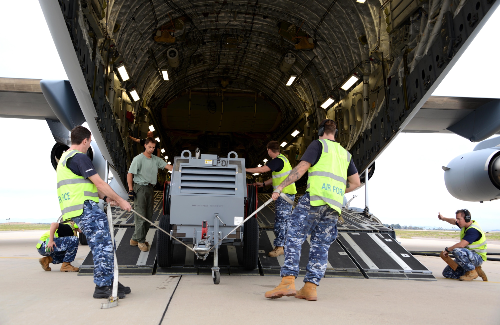 Royal Australian air force airmen prepare to load a pallet onto a RAAF C-17 Globemaster III cargo aircraft Feb. 22, 2017, at Luke Air Force Base, Ariz. Through logistical planning and preparation, supply equipment is carefully loaded onto aircraft in order to balance the pay load. (U.S. Air Force photo by Airman 1st Class Alexander Cook) 