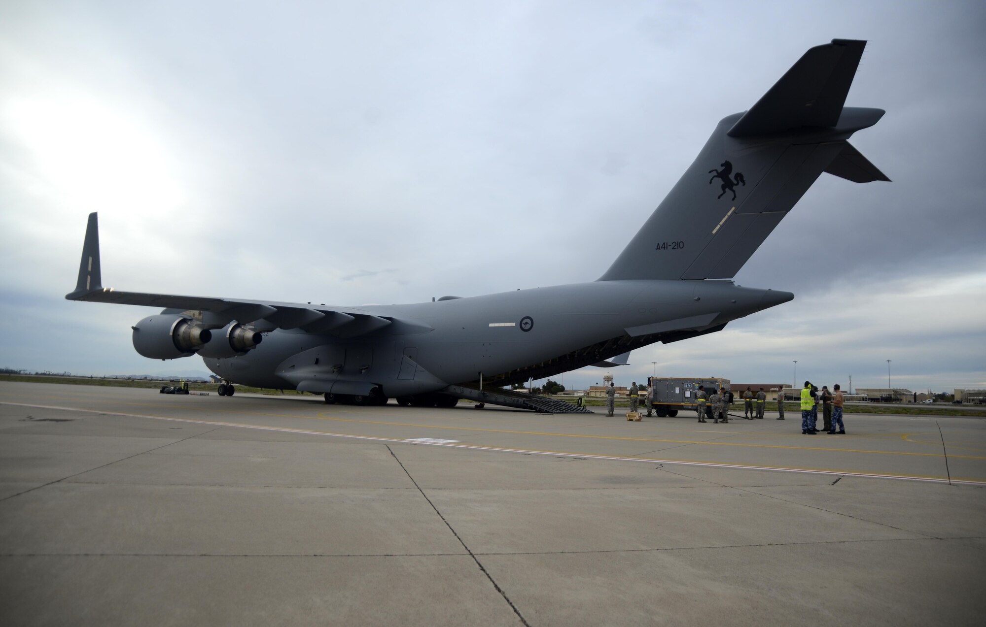 Luke Airmen and Royal Australian air force airmen work together to load a RAAF C-17 Globemaster III cargo aircraft Feb. 22, 2017, at Luke Air Force Base, Ariz. Luke Airmen worked alongside RAAF airmen to load the C-17 in support of their upcoming air show. (U.S. Air Force photo by Airmen 1st Class Alexander Cook)