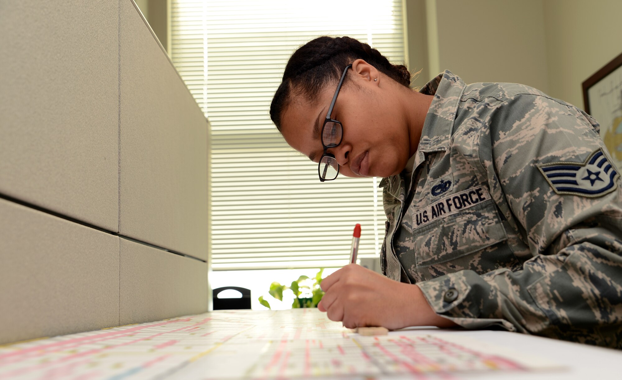 Staff Sgt. Kursten Harris, 62nd Maintenance Group plans, scheduling and documentation office NCO in charge, reviews schedules Feb. 22, 2017 at Joint Base Lewis-McChord, Wash. The 62nd MXG plans, scheduling and documentation office schedules hundreds of maintenance actions yearly for aircraft and track past, current and future maintenance actions. (U.S. Air Force photo/Senior Airman Jacob Jimenez)