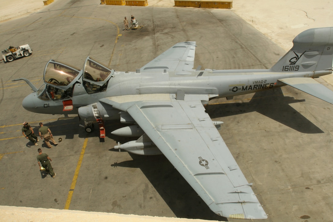 Maintenance Marines with Marine Tactical Electronic Warfare Squadron 2, Marine Aircraft Group 16 (Reinforced), 3rd Marine Aircraft Wing (Forward), begin a post-flight inspection of an EA-6B Prowler at Al Asad, Iraq, June 18, 2006. The "Death Jester's" wrench turners were a critical force behind the squadron reaching a 3,000 flight hours milestone July 13.(Marine Corps photo by Cpl. Jonathan Televich/ Released)