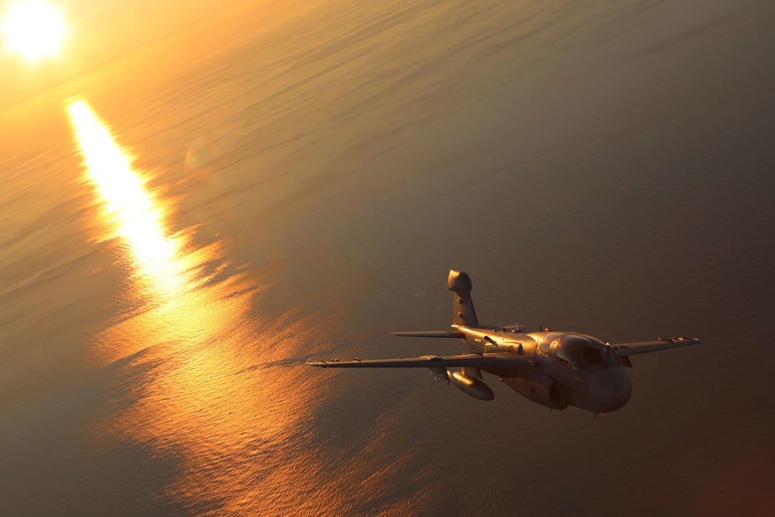 An EA-6B Prowler, belonging to 2nd Marine Aircraft Wing glides through cascading sunlight while conducting aerial maneuvers during an air-to-air refuel training exercise over the Atlantic Ocean Sept. 14, 2015. Aircraft from Marine Corps Air Station Cherry Point, N.C., were supported by Marine Aerial Refueler Transport Squadron 252 off the eastern Atlantic coast during the training exercise to hone their aerial refueling skills. VMGR-252 is the force multiplier for the Marine Air-Ground Task Force as it extends the operational reach of other aviation platforms under all weather conditions, day or night during expeditionary, joint or combined operations. (U.S. Marine Corps photo by Cpl. N.W. Huertas/Released)