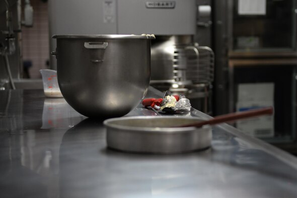Cake batter-coated ice cream scoops lay on the table after filling 20 cupcake tins with batter Feb. 22, 2017, at Eielson Air Force Base, Alaska. The Two Seasons Dining Facility prepared cupcakes for Airmen whose birthday falls in the first quarter. (U.S. Air Force photo by Airman 1st Class Cassandra Whitman)