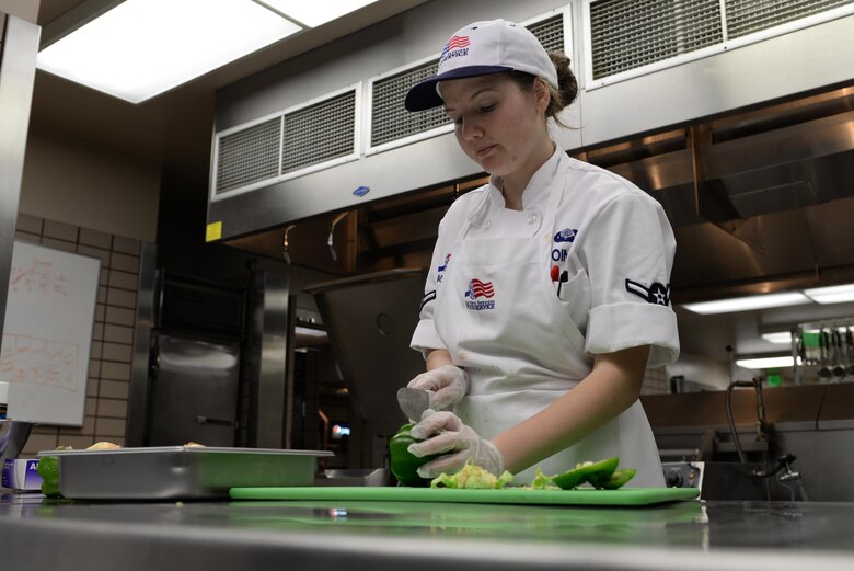 U.S. Air Force Airman Yulia Goings, a 354th Force Support Squadron food service apprentice, chops peppers and onions for lunch Feb. 22, 2017, at Eielson Air Force Base, Alaska. The Two Seasons Dining Facility prepares breakfast, lunch and dinner for the Iceman Team. (U.S. Air Force photo by Airman 1st Class Cassandra Whitman)