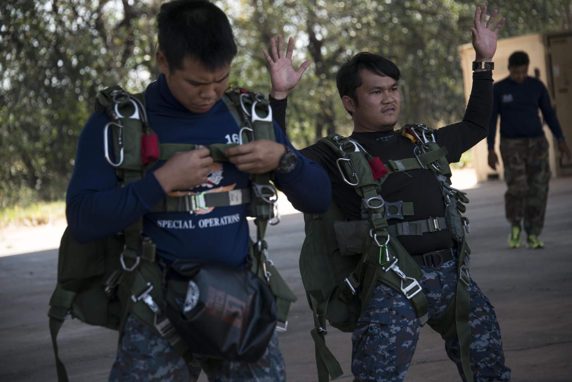 Royal Thai Air Force Special Operations Regiment pararescuemen prepare their parachute equipment prior to water recovery operations with counterparts from the 320th Special Tactics Squadron, Feb. 17, 2017 at Korat Air Base, Thailand. Throughout Cobra Gold 2017, the 320th STS and RTAF SOR pararescuemen trained side-by-side to strengthen relationships and increase interoperability. (U.S. Air Force photo by Capt. Jessica Tait)