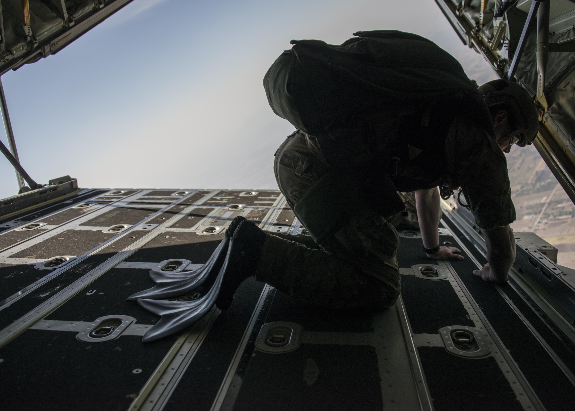 A U.S. Air Force jump master assigned to the 320th Special Tactics Squadron identifies the water drop zone prior to bilateral jump operations from a U.S. Air Force MC-130J Commando II assigned to 17th Special Operations Squadron, Feb. 17, 2017 at Korat Air Base, Thailand. Pararescuemen from the 320th STS and Royal Thai Air Force Special Operations Regiment exercised water recovery operations as a part of Cobra Gold 2017. (U.S. Air Force photo by Capt. Jessica Tait)