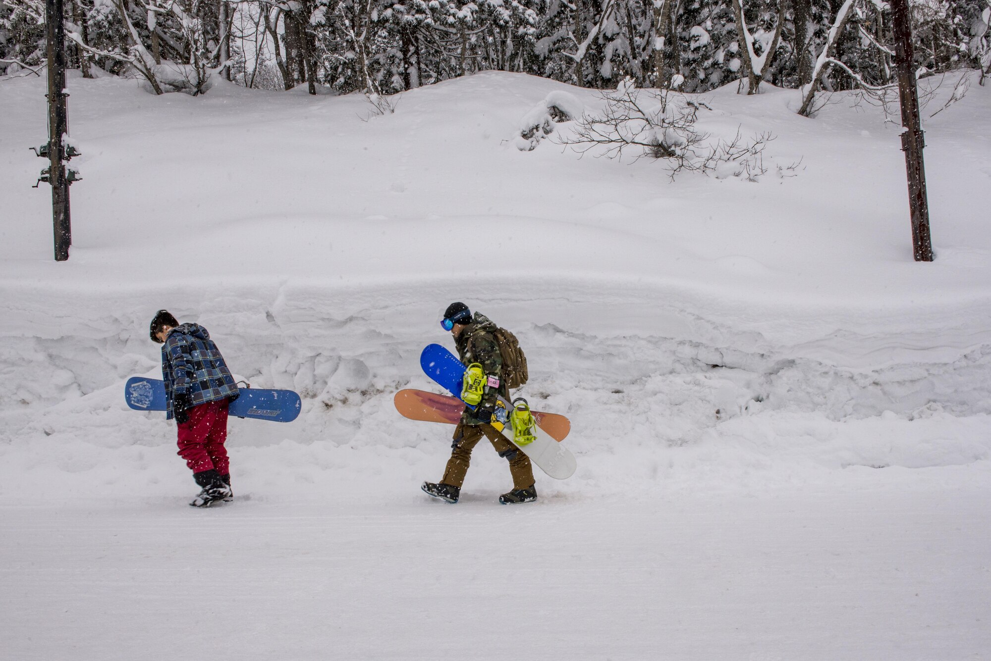 Participants in the 374th Force Support Squadron Outdoor Recreation trip to Myoko-Suginohara ski resort walk to the entrance along a tall snowbank Feb. 11, 2017, in the Niigata prefecture, Japan. Yokota Outdoor Recreation offers trips for Yokota personnel and their families though out the year, ranging from hiking, whitewater rafting, fishing, ski/snowboarding and a variety of other activates depending on the season. (U.S. Air Force Photos by Airman 1st Class Donald Hudson)