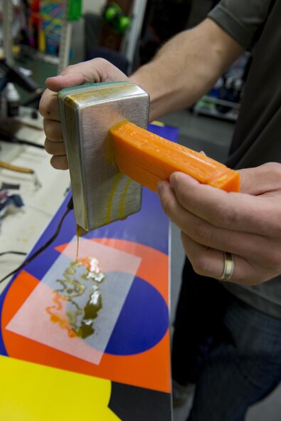 Matthew Silvia, 374th Force Support Squadron Outdoor Recreation recreation aid, melts wax onto a snowboard base Feb. 16, 2017, at Yokota Air Base, Japan. Yokota’s Outdoor Recreation maintains rental equipment as well as customers personal skis and snowboards. (U.S. Air Force Photos by Airman 1st Class Donald Hudson)