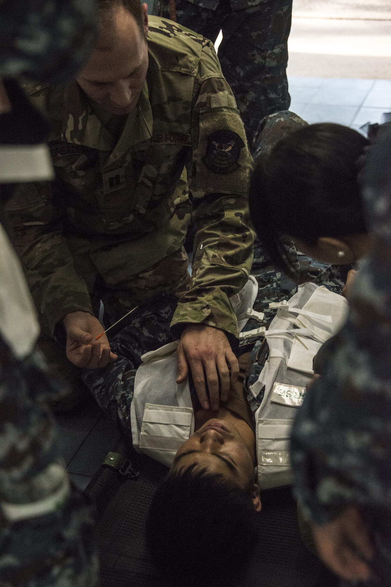 U.S. Air Force Capt. Zachary Dreaden, 353rd Special Operations Support Squadron flight surgeon, demonstrates a technique on how to perform a needle decompression to counterparts from the Royal Thai Air Force Wing 1 Hospital during a medical exchange, Feb. 22, 2017 at Korat Air Base, Thailand. The medical activities conducted during Cobra Gold 2017 supported the needs and humanitarian interests of civilian populations across the region. (U.S. Air Force photo by Capt. Jessica Tait)