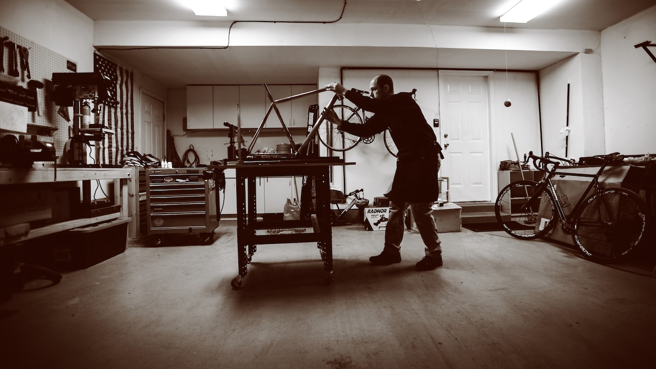 Air Force 1st Lt. Ken Cerreta checks the alignment on a handmade bicycle frame. Cerreta began building custom steel frames in 2014. (Paul Holcomb/U.S. Air Force)