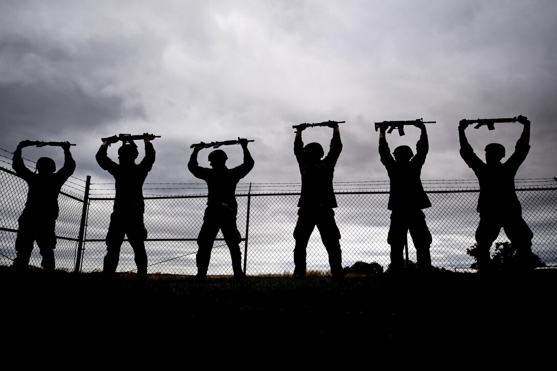 Air Force Academy cadets hold training rifles during obstacle training at an officer aptitude assessment at Camp Bullis, Texas, Feb. 14, 2017. Air Force photo by Airman 1st Class Daniel Snider