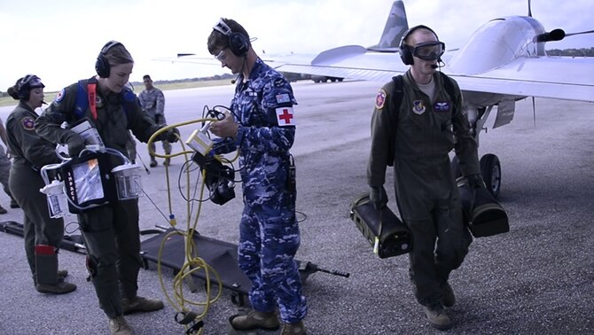 Aeromedical Evacuation Airmen from the U.S., Japanese and Australian air forces transport a simulated patient to a U.S. Air Force C-12 Huron as part of annual exercise Cope North Feb. 21, 2017, at Tinian Air Field. Aeromedical evacuation training was conducted on the Huron to familiarize airmen with patient care on a new airframe. Cope North is a long-standing exercise designed to enhance multilateral air operations between the partnered militaries, bringing together more than 2,700 U.S. Airmen, Sailors and Marines who are training alongside approximately 600 combined JASDF and RAAF participants.  (Courtesy photo)