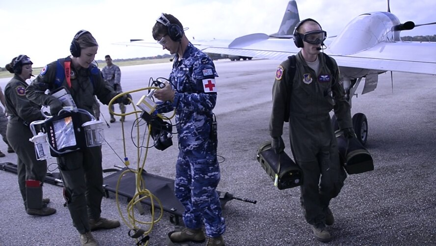 Aeromedical Evacuation Airmen from the U.S., Japanese and Australian air forces transport a simulated patient to a U.S. Air Force C-12 Huron as part of annual exercise Cope North Feb. 21, 2017, at Tinian Air Field. Aeromedical evacuation training was conducted on the Huron to familiarize airmen with patient care on a new airframe. Cope North is a long-standing exercise designed to enhance multilateral air operations between the partnered militaries, bringing together more than 2,700 U.S. Airmen, Sailors and Marines who are training alongside approximately 600 combined JASDF and RAAF participants.  (Courtesy photo)