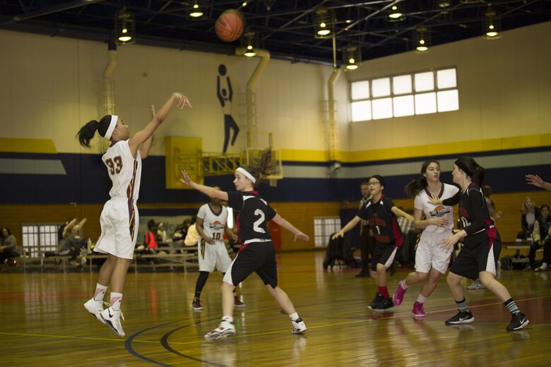 Sakura Fleming, left, a forward for Matthew C. Perry High School’s Lady Samurai basketball team, takes a shot against a defender during the 2017 Division 2 Girls’ Basketball Tournament at the IronWorks Gym on Marine Corps Air Station Iwakuni, Japan, Feb. 22, 2017. M.C. Perry High School hosted 11 teams from the Far East Division for the tournament. The teams endured two days of physically demanding competition for the opportunity at a championship game in a double elimination style tournament. (U.S. Marine Corps photo by Lance Cpl. Joseph Abrego)