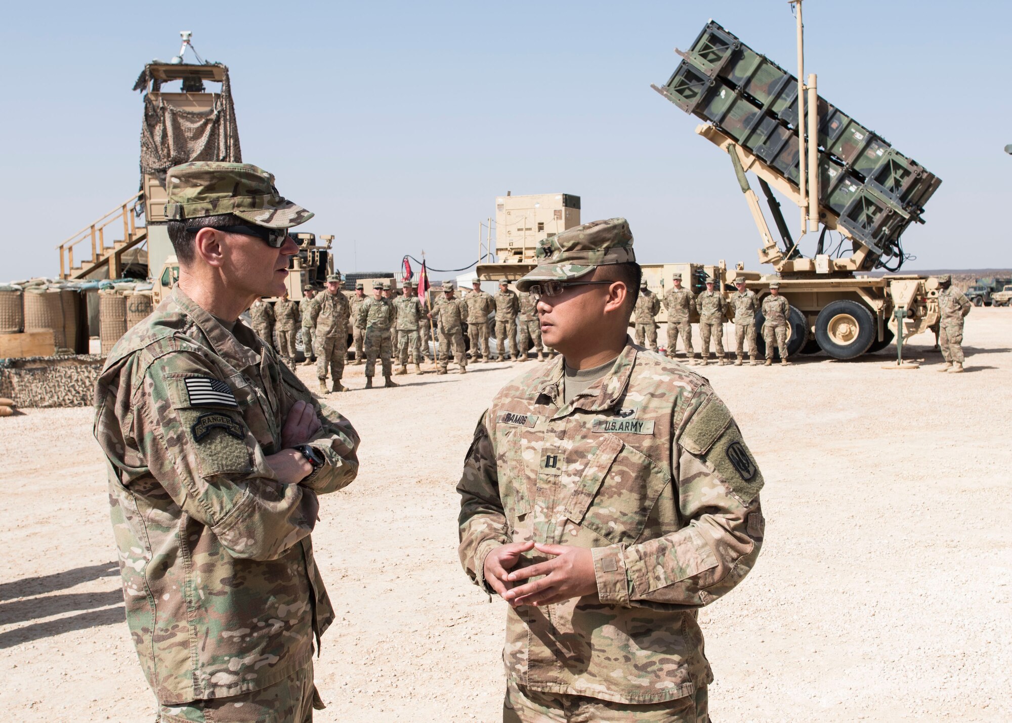 Gen. Joseph Votel, U. S. Central Command commander, speaks with Capt. Richard Ramos, 3rd Battalion, 321st Field Artillery Regiment Able Battery commander, at an undisclosed location in Southwest Asia. Ramos explained the mission and current operations of the High Mobility Artillery Rocket System. (U.S. Air Force photo/Staff Sgt. Eboni Reams)