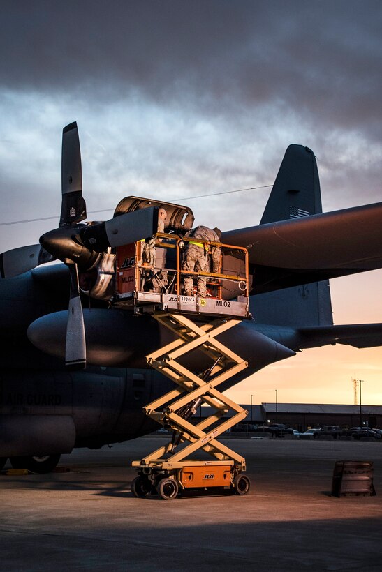 Airmen work on the engine of a C-130H Hercules aircraft as the sun rises over Mansfield Lahm Air National Guard Base, Mansfield, Ohio, Feb. 21, 2017. Air National Guard photo by 1st Lt. Paul Stennett