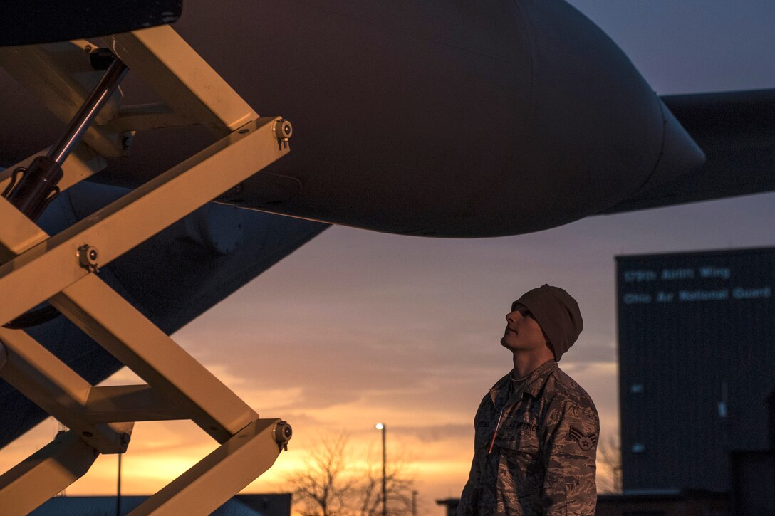 Air Force Senior Airman Hunter Mitchell inspects an engine of a C-130H Hercules as the sun rises over Mansfield Lahm Air National Guard Base, Mansfield, Ohio, Feb. 21, 2017. Mitchell is an aerospace propulsion specialist assigned to the Ohio Air National Guard’s 179th Airlift Wing. Air National Guard photo by 1st Lt. Paul Stennett