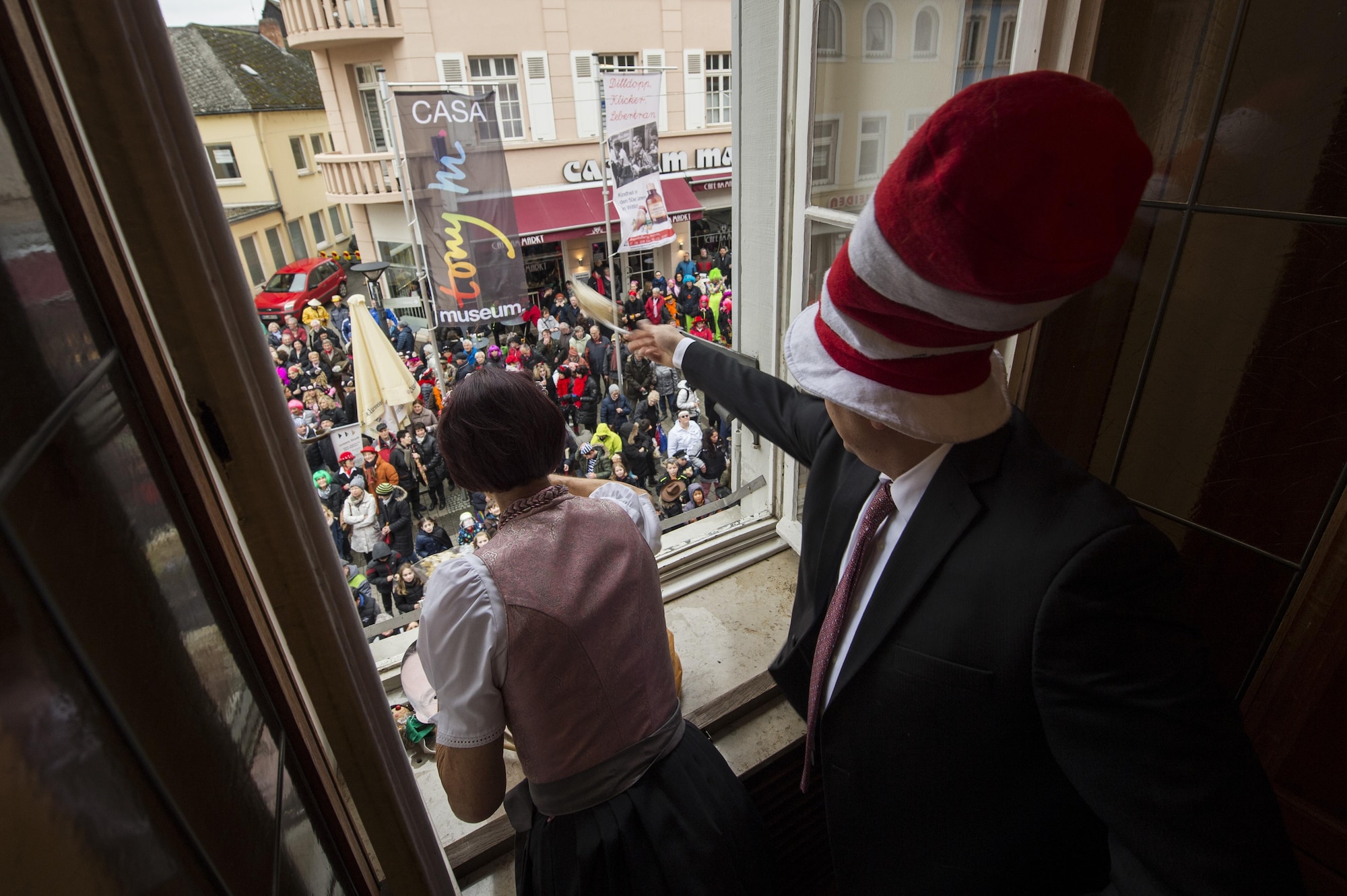 Col. Steven Zubowicz, 52nd Mission Support Group commander, throws candy to the crowd below city hall during a Fasching celebration in Wittlich, Germany, Feb. 23, 2017. The celebration included a tradition of female citizens storming the city hall to seize control of the community for the day. (U.S. Air Force photo by Staff Sgt. Jonathan Snyder)