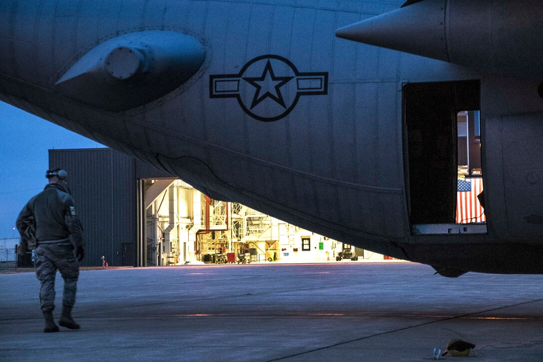 Airmen move a C-130H Hercules out of a hangar to be worked on as the sun rises over Mansfield Lahm Air National Guard Base, Mansfield, Ohio, Feb. 21, 2017. Air National Guard photo by 1st Lt. Paul Stennett   
