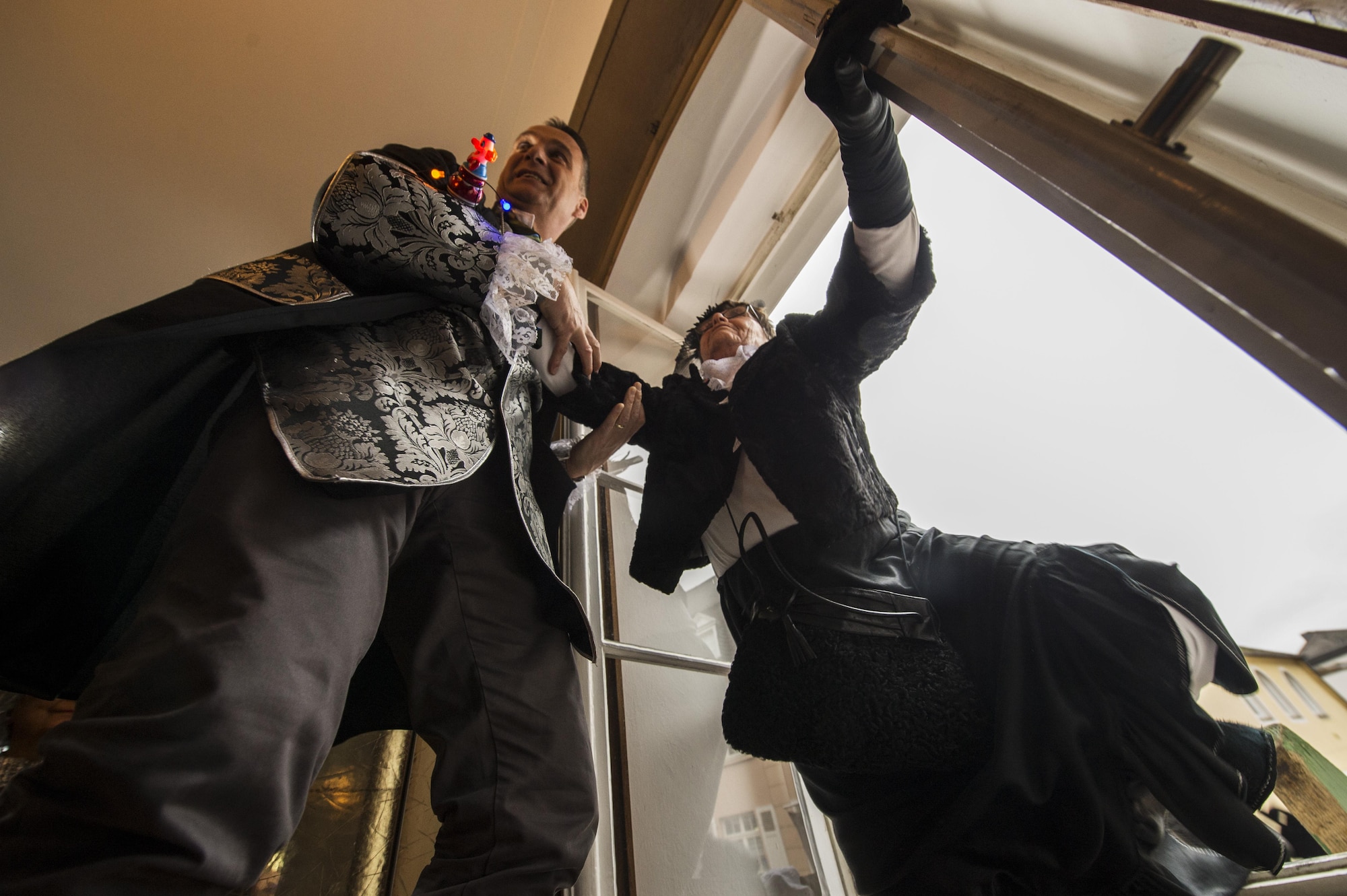 Joachim Rodenkirch, left, mayor of Wittlich, helps a local German woman through a window at city hall during a Fasching celebration in Wittlich, Germany, Feb. 23, 2017. Once the ladies have “taken over” the city hall, the celebrations begin with dancing and parading throughout the city. The traditional Fasching celebrations begin the Thursday prior to Lent at the 11th minute past the 11th hour, continue until Ash Wednesday and allow people to indulge before the Lent season. (U.S. Air Force photo by Staff Sgt. Jonathan Snyder)