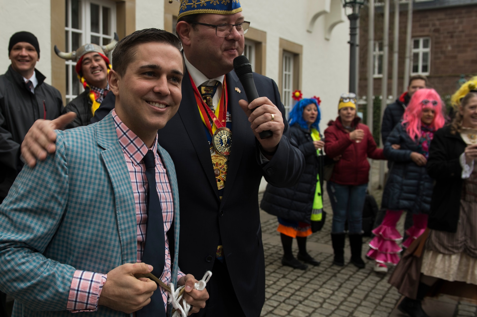 Airman 1st Class Preston Cherry, 52nd Fighter Wing Public Affairs photojournalist, is presented with a key by Joachim Kandels, Bitburg mayor, during the 2017 Storming of the Rathaus Fasching event in Bitburg, Germany, Feb. 23, 2017. The women captured the key, symbolizing they had taken control of the city as part of the holidays tradition. (U.S. Air Force photo by Senior Airman Dawn M. Weber)