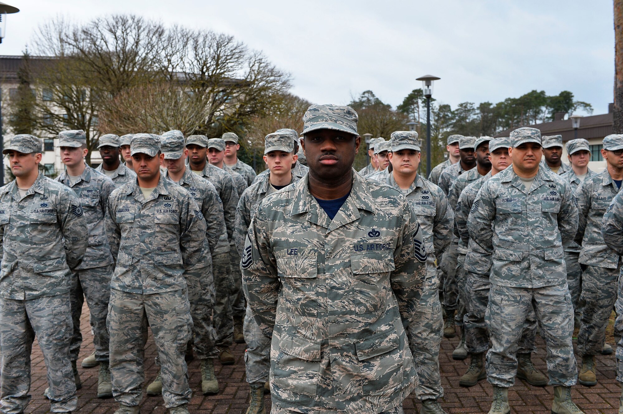 786th Civil Engineer Squadron Airmen stand at parade rest during a memorial service for the River Rats Memorial monument on Ramstein Air Base, Germany, Feb. 17, 2017. The Red River Rats Fighter Pilots Association, which was formed during the Vietnam War, established the monument at Ramstein in 1976 to commemorate Airmen who never returned from Vietnam. The 786th CES recently repaired the monument, which had fallen into disrepair over the years. (U.S. Air Force photo by Airman 1st Class Joshua Magbanua)