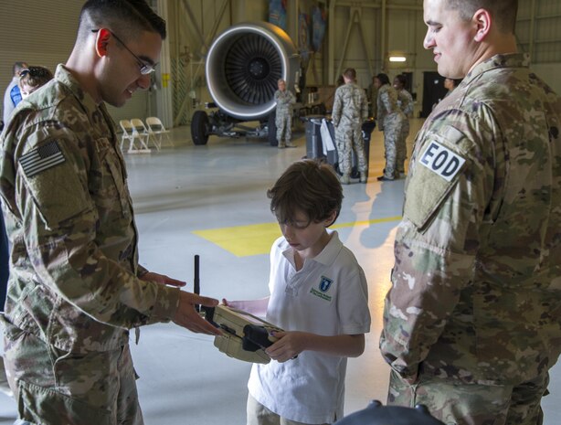 Members of the 628th Civil Engineering Squadron Explosive Ordnance Disposal flight from Joint Base Charleston, S.C. explains the remotely operated robots to a student from the University School of the Lowcountry. More than 150 students from middle and high school boys from 17 Lowcountry school visited Joint Base Charleston Feb. 23, 2017, to learn about jobs in aviation as part of the second annual Tuskegee Airmen Career Day, hosted by the 315th Airlift Wing. The boys were able to learn about military and civilian careers in aviation by more than 15 different career fields. (U.S. Air Force photo by Senior Airman Tom Brading)