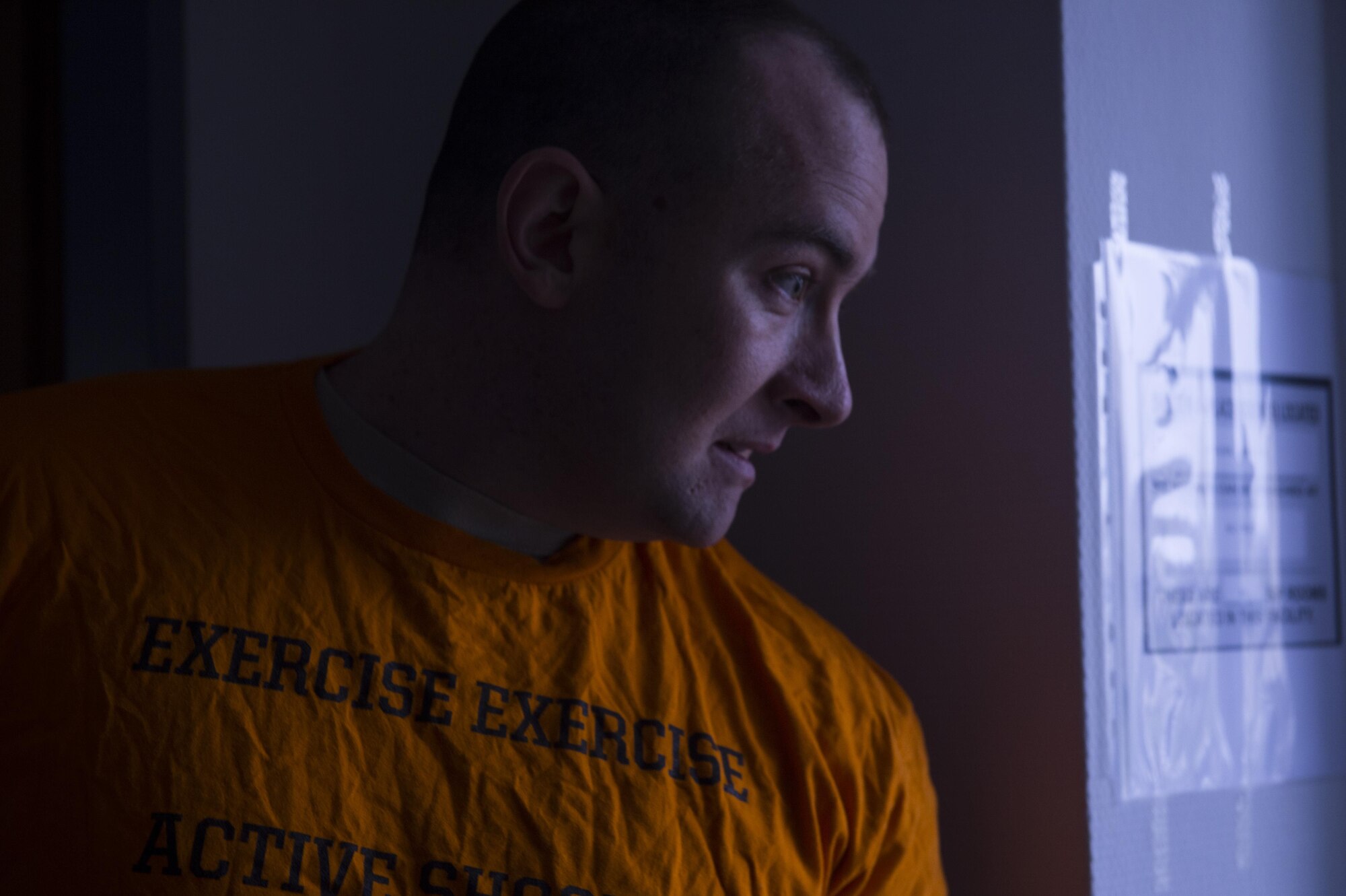 U.S. Air Force Tech. Sgt. Jason Plasner, 52nd Fighter Wing executive assistant to the command chief, peers around a corner before simulating firing a dummy weapon during an active shooter exercise at Spangdahlem Air Base, Germany, Feb. 22, 2017. The Inspector General’s office conducts these types of exercises throughout the year in order to ensure all personnel are properly trained to respond accordingly to an active shooter situation. (U.S. Air Force photo by Senior Airman Dawn M. Weber)