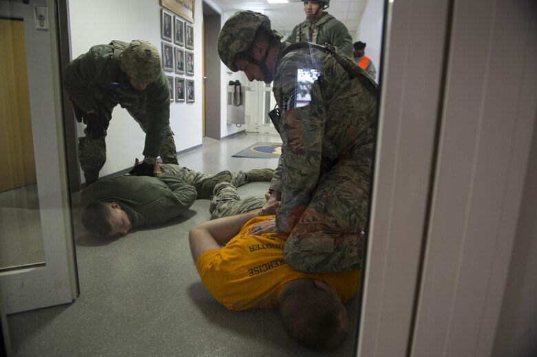 U.S. Air Force Tech. Sgt. Jason Plasner, 52nd Fighter Wing executive assistant to the command chief, acts as an active shooter during an exercise at Spangdahlem Air Base, Germany, Feb. 22, 2017. The realistic scenario involved a disgruntled Airman simulating an active shooter attack on the base. (U.S. Air Force photo by Senior Airman Dawn M. Weber)