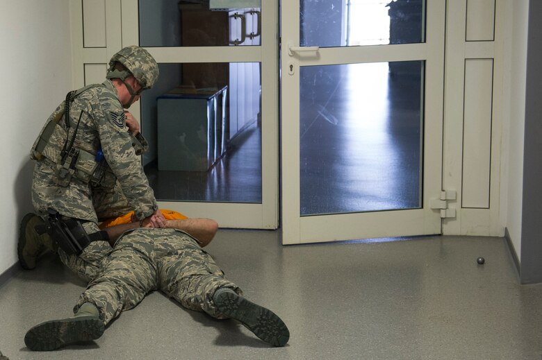 A 52nd Security Forces Squadron Airman apprehends U.S. Air Force Tech. Sgt. Jason Plasner, 52nd Fighter Wing executive assistant to the command chief, during an active shooter exercise at Spangdahlem Air Base, Germany, Feb. 22, 2017. Active shooter exercises give Security Forces Airmen a chance to test their capabilities in a realistic situation and environment. (U.S. Air Force photo by Senior Airman Dawn M. Weber)