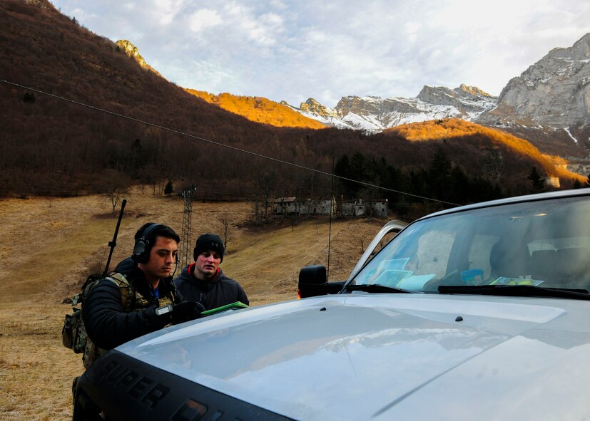 Senior Airman Mark Brush, 2nd Air Support Operations Squadron joint tactical air controller, and Airman 1st Class Jeremy Mootz, 31st Medical Support Squadron medical logistics technician, review a terrain map during a routine training mission at Aviano Air Base, Italy, Feb. 17, 2017. Mootz shadowed a JTAC team to educate him on JTAC operations. Mootz was selected for retraining as an Air Liaison Officer, which is a commissioned position as a JTAC. (U.S. Air Force photo by Staff Sgt. Austin Harvill)