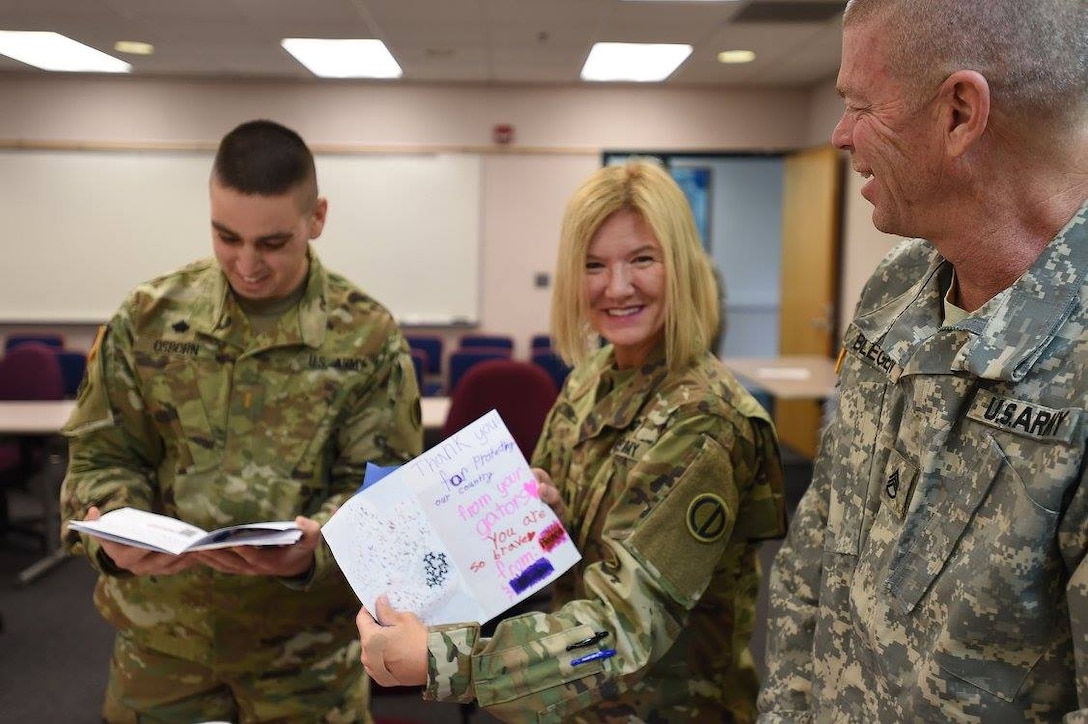 Army Reserve Soldiers assigned to the 85th Support Command's headquarters staff read 'Thank You' letters sent from a local elementary school, Jan. 8, 2017.
More than 170 letters were sent with personal expressions of thanks and drawings from the students.
(Photo by Sgt. Aaron Berogan)

