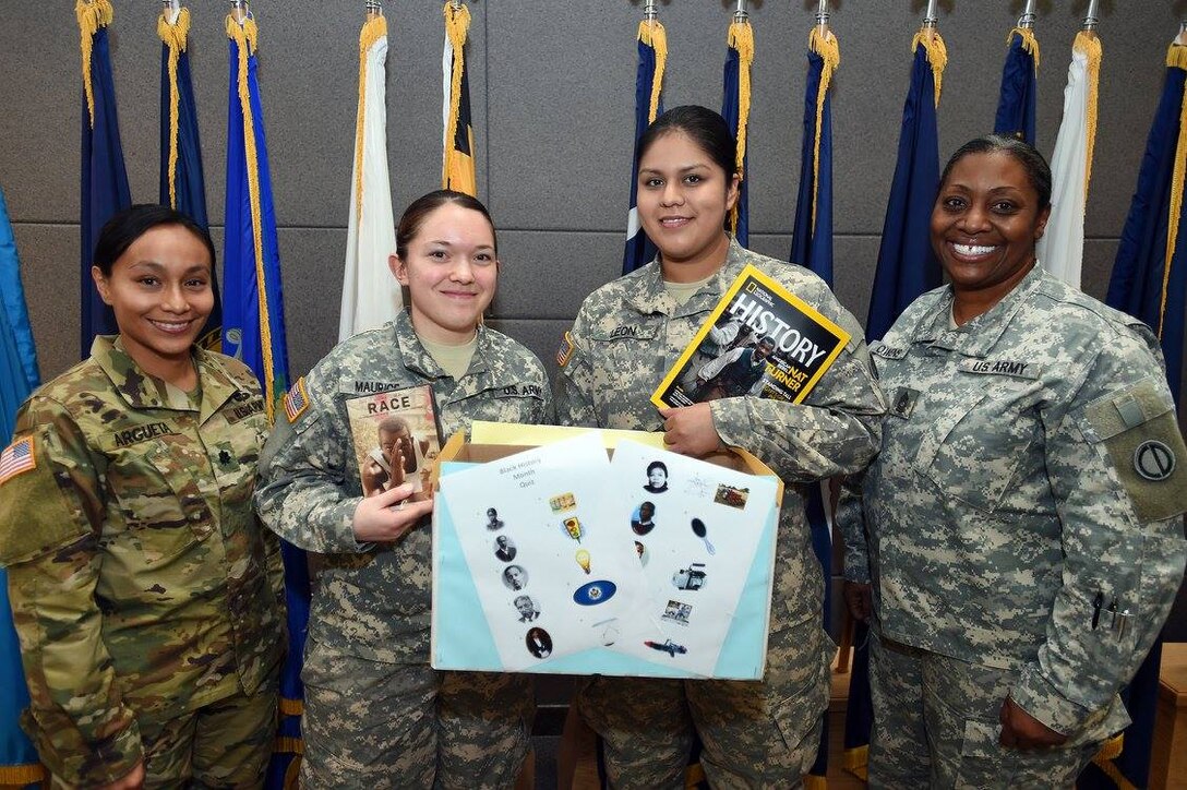 Army Reserve Soldiers assigned to the 85th Support Command headquarters pause for a photo with the command's Equal Opportunity team after winning a knowledge contest during the command's Black History Month observance, Feb 12, 2017.
(Photo by Sgt. Aaron Berogan)