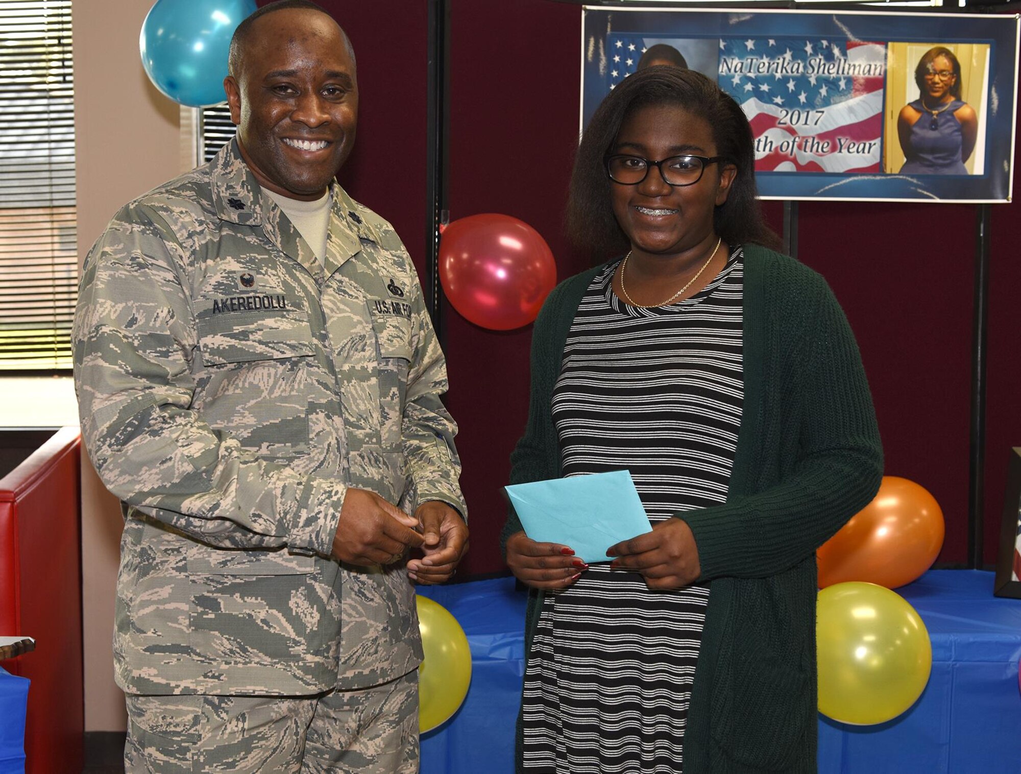 Lt. Col. Daniel Akeredolu, 14th Force Support Squadron Commander, presents Naterika Symon Shellman, daughter of Stanley and Natarsha Shellman, with the 2017 Youth of the Year Award for Columbus Air Force Base, Mississippi, Feb. 8, 2017, at the Youth Center. Naterika participated in the statewide competition Feb. 15-17 in Jackson, Mississippi, where she placed second in the state. Her goal is to attend Mississippi State University in Business and Fashion Merchandising. (U.S. Air Force photo by Elizabeth Owens)