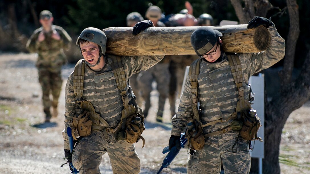 Air Force Academy cadets carry a log during a medical evacuation march at Camp Bullis, Texas, Feb. 16, 2017. The cadets were required to trek multiple miles carrying logs and simulated casualties to a medical evacuation zone in limited time. Air Force photo by Airman 1st Class Daniel Snider