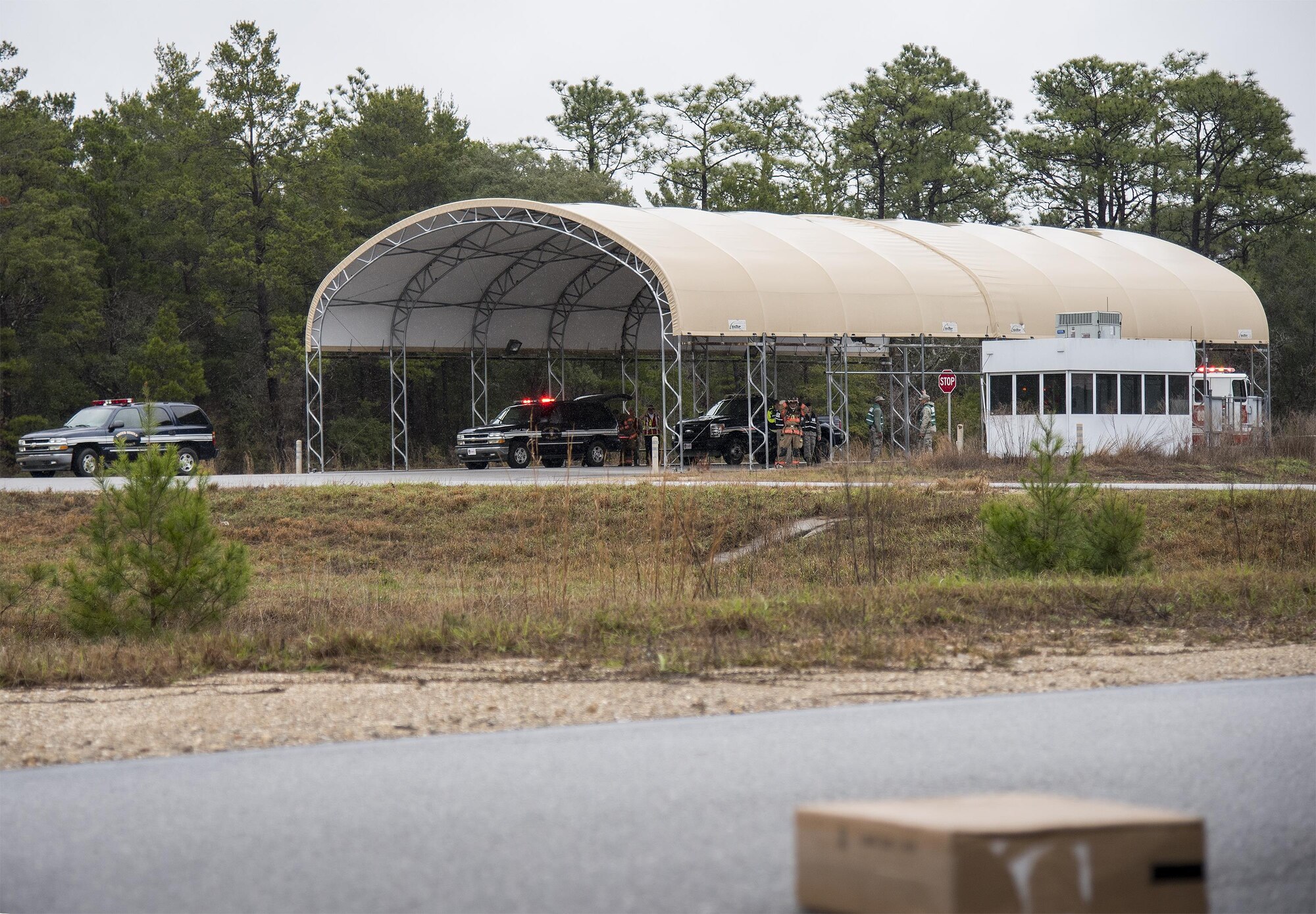 Emergency responders begin their procedures while keeping their distance from a suspicious package during an exercise Feb. 22 at Eglin Air Force Base, Fla.  The chemical, biological, nuclear response exercise tested the procedures of emergency response, explosive ordnance disposal, emergency management and bioenvironmental agencies among others.  (U.S. Air Force photo/Samuel King Jr.)