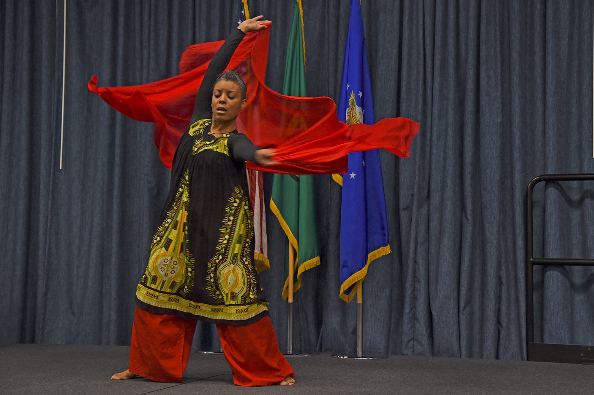 Mona Martin performs a South African tribal dance during the National Black History Month luncheon Feb. 23, 2017, at Fairchild Air Force Base, Washington. The dance performed was based on the original culture musical and movement styles. A tribal dance is a type of dance used to symbolize the origin of one's connection with their culture. (U.S. Air Force photo/Senior Airman Mackenzie Richardson)