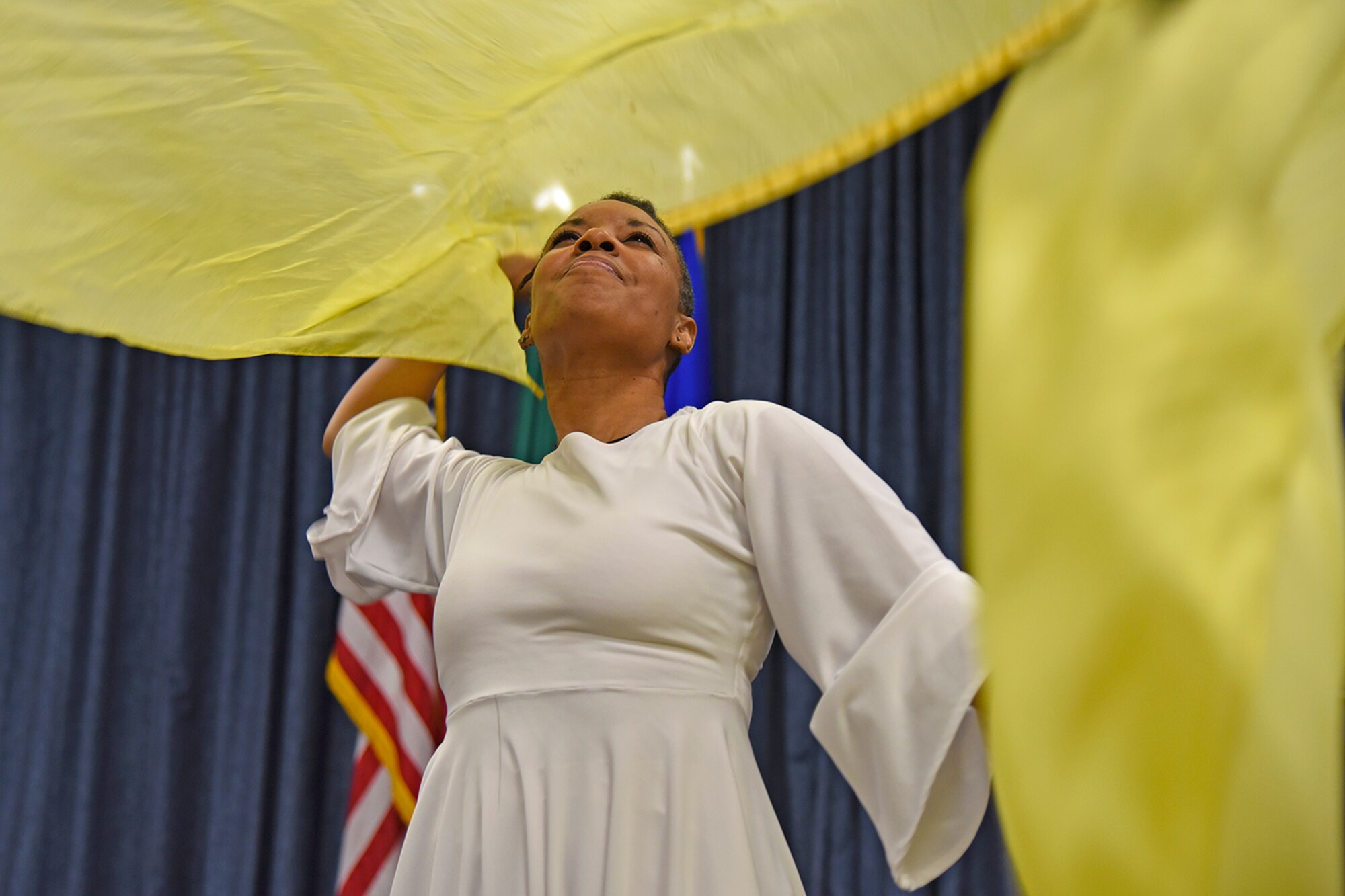 Mona Martin performs a praise dance during the National Black History Month luncheon Feb. 23, 2017, at Fairchild Air Force Base, Washington. Praise dance or liturgical dance is a type of dance incorporated into liturgies and worship services as an expression of worship to enhance the prayer or worship experience. (U.S. Air Force photo/Senior Airman Mackenzie Richardson)