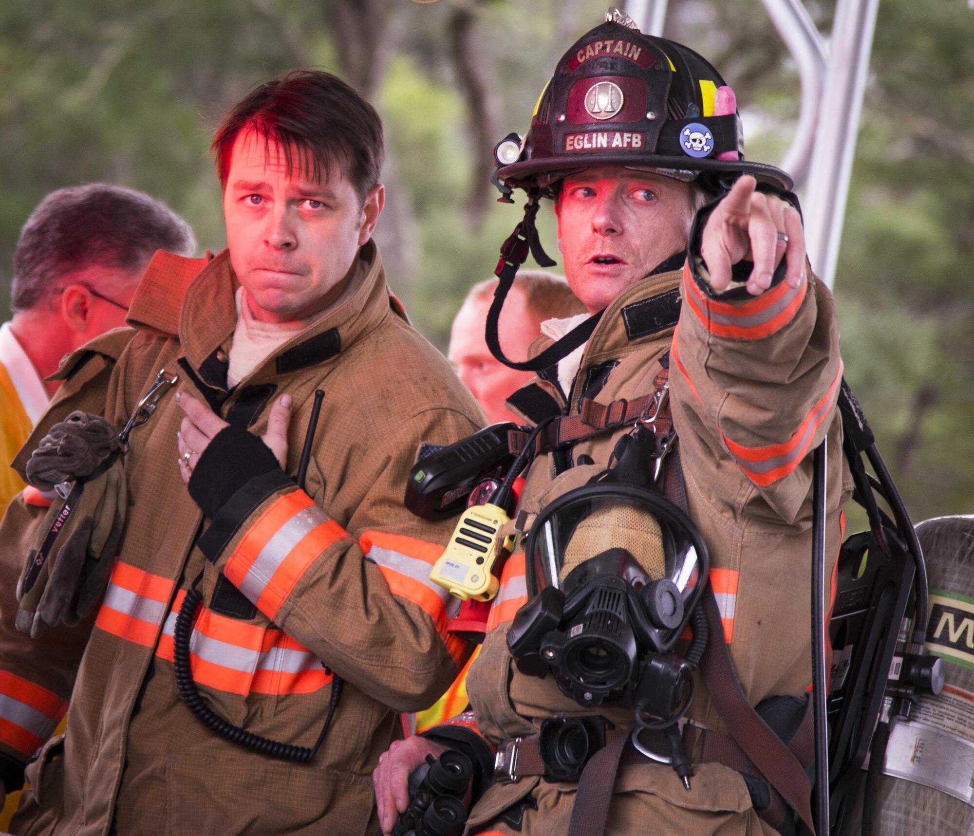 Firefighters with the 96th Test Wing discuss a suspicious package in the distance during an exercise Feb. 22 at Eglin Air Force Base, Fla.  The chemical, biological, nuclear response exercise tested the procedures of emergency response, explosive ordnance disposal, emergency management and bioenvironmental agencies among others.  (U.S. Air Force photo/Samuel King Jr.)