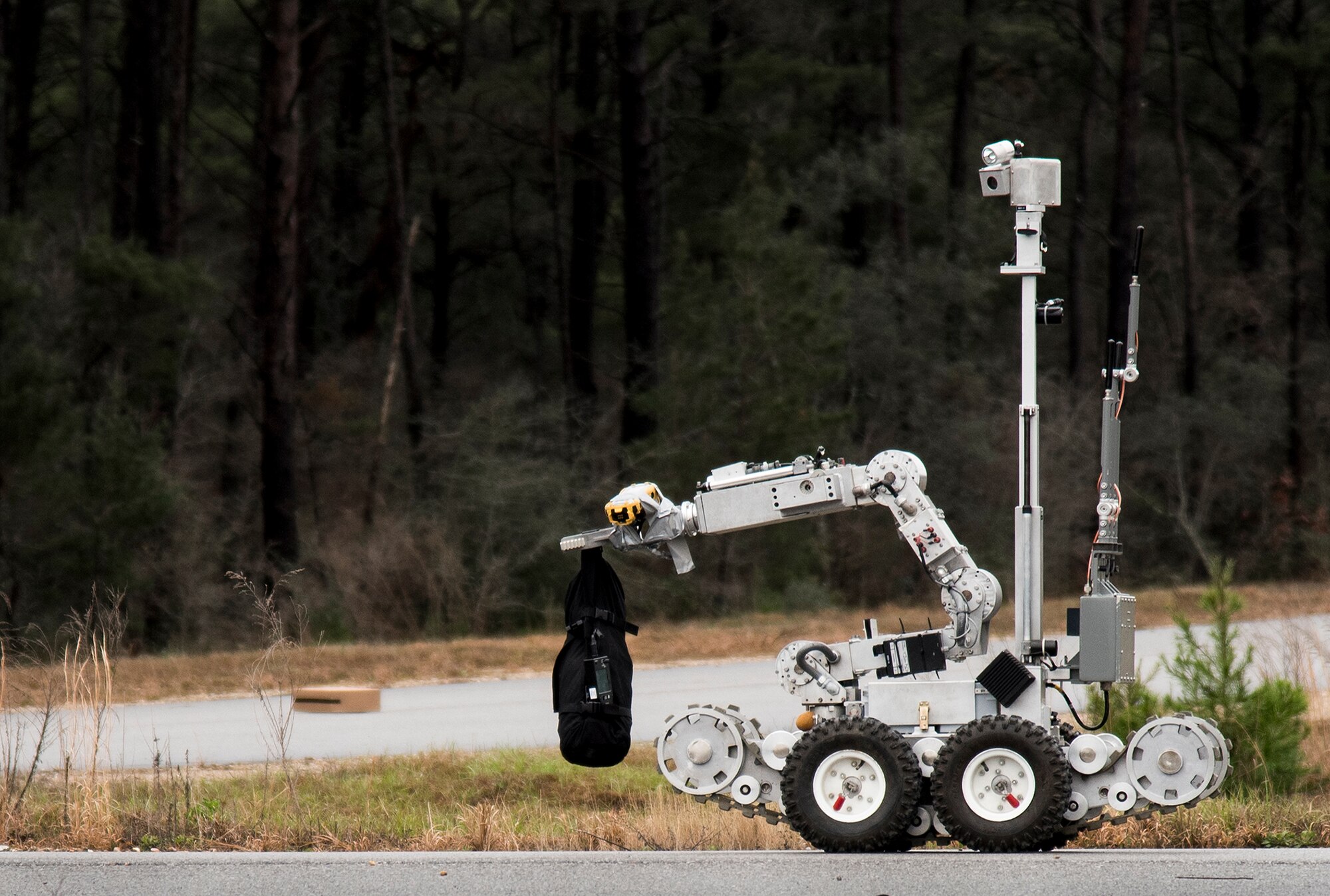 An explosive ordnance disposal robot approaches a suspicious package during an exercise Feb. 22 at Eglin Air Force Base, Fla.  The chemical, biological, nuclear response exercise tested the procedures of emergency response, explosive ordnance disposal, emergency management and bioenvironmental agencies among others.  (U.S. Air Force photo/Samuel King Jr.)