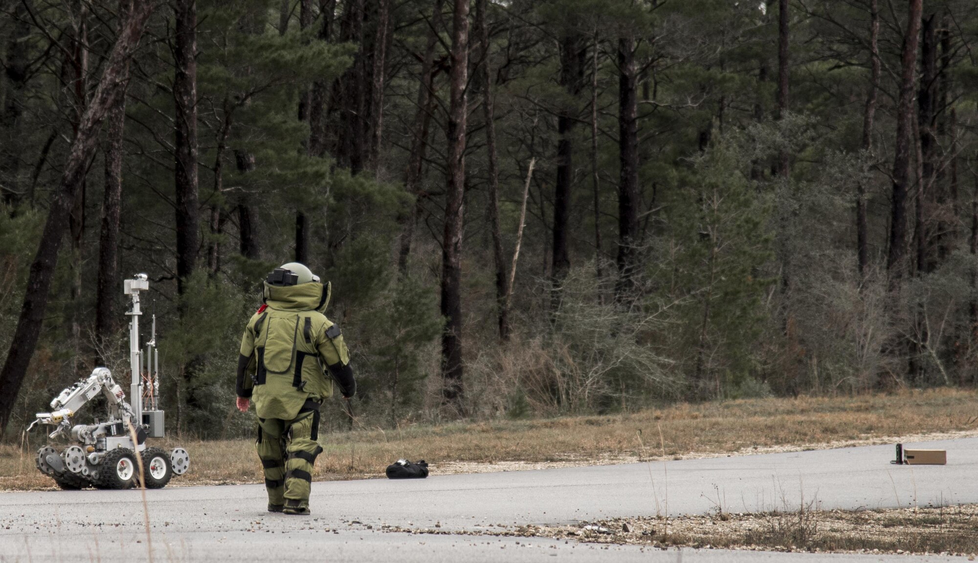 An explosive ordnance disposal Airman approaches a suspicious package during an exercise Feb. 22 at Eglin Air Force Base, Fla.  The chemical, biological, nuclear response exercise tested the procedures of emergency response, explosive ordnance disposal, emergency management and bioenvironmental agencies among others.  (U.S. Air Force photo/Samuel King Jr.)